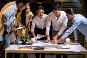 Picture of a group of employees working around a table.